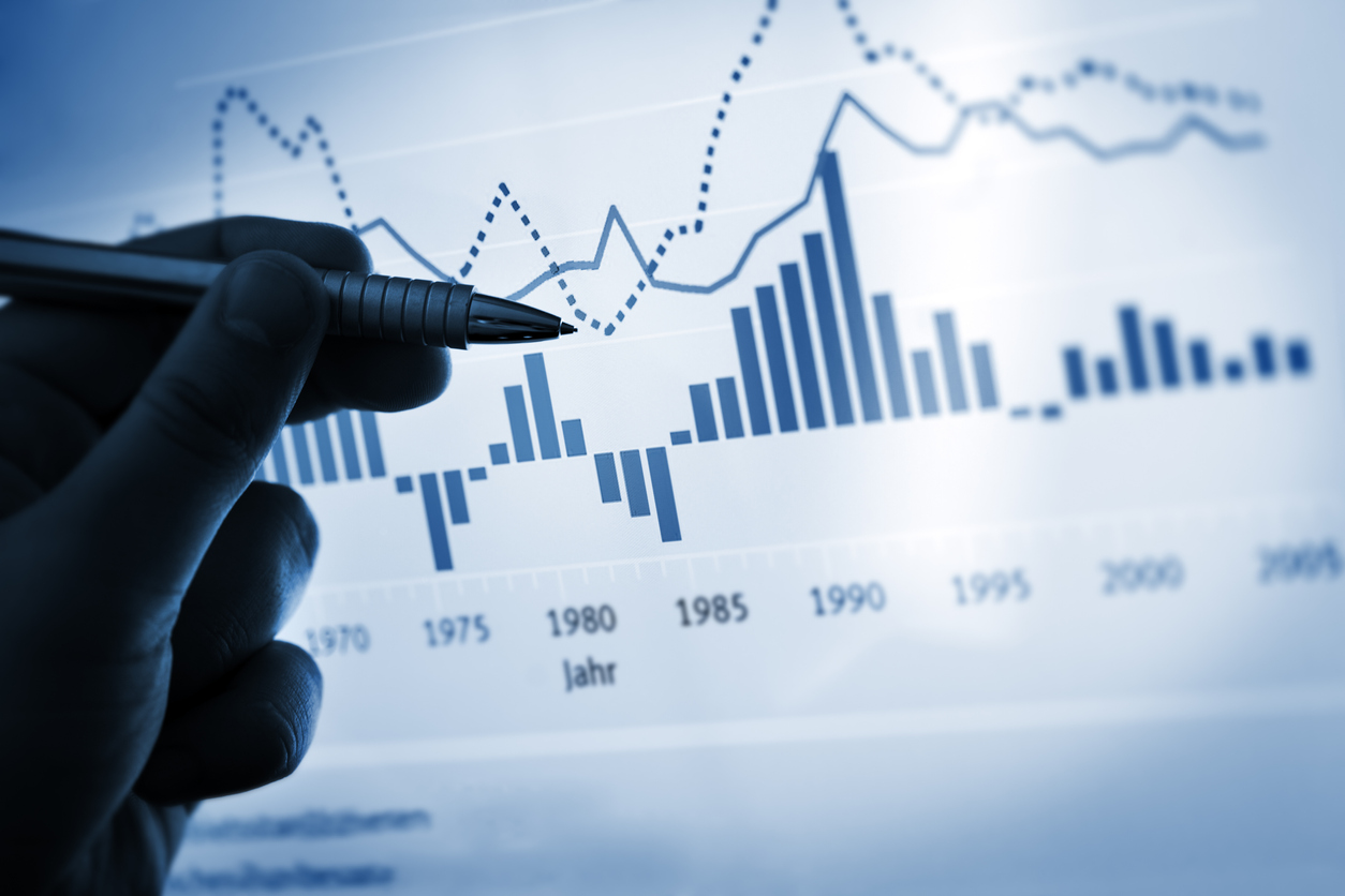 Hand pointing with pen on a computer chart / document