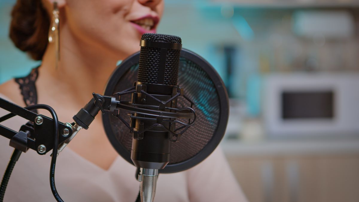 Close up of woman talking in the microphone.