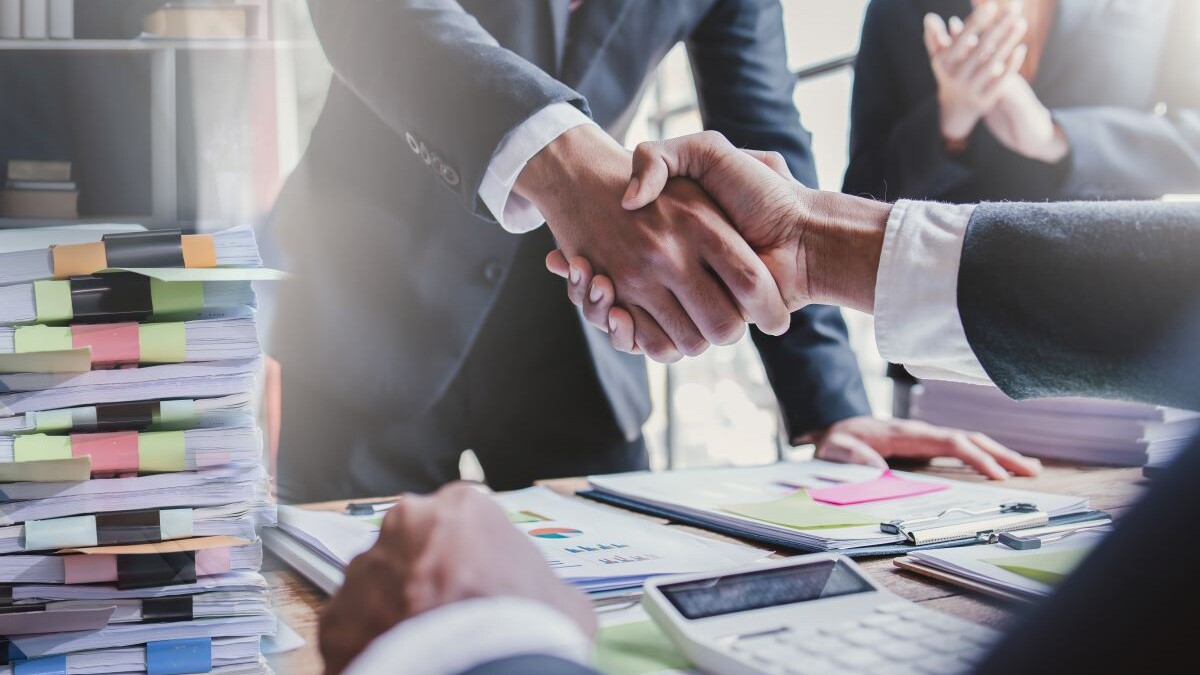 Business handshake for teamwork of business merger and acquisition